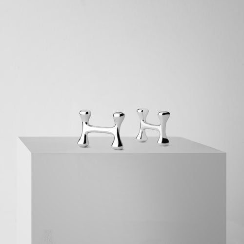 H-OS silver cufflinks on a stand